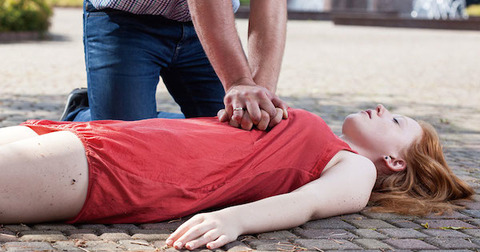 woman having CPR performed on her