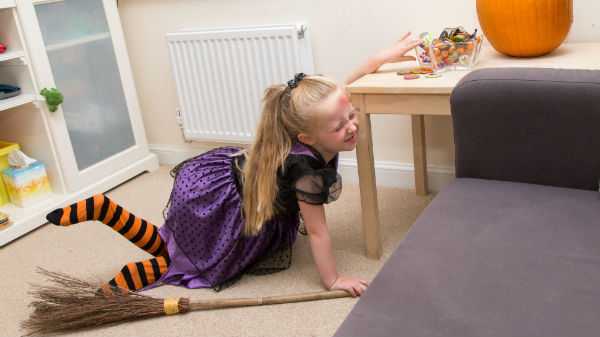 Child in pain after eating too much sugar at halloween