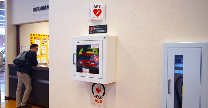 Defibrillator in wall cabinet with signage