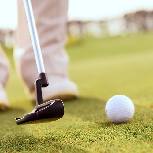 Close up of a golf ball and golf club