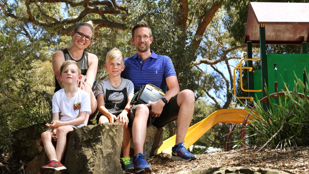 family with defibrillator at park